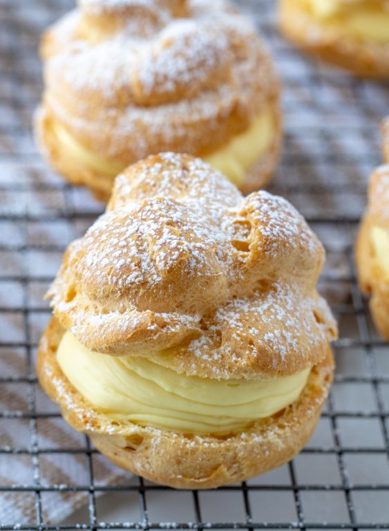My famous authentic Homemade Cream Puffs recipe: light and airy cream puffs filled with vanilla pudding cream are always a hit with family and anyone I