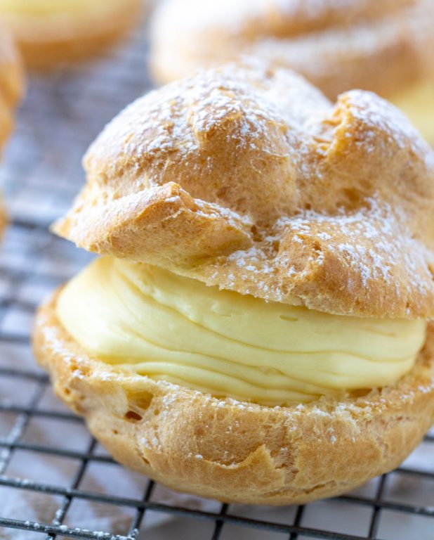 My famous easy, authentic Homemade Cream Puffs recipe: light and airy cream puffs filled with vanilla pudding cream are always a hit with family and anyone I