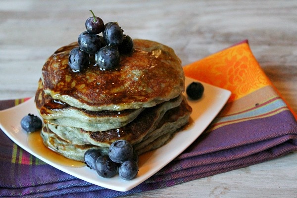 stack of blueberry Greek Yogurt Pancakes with syrup